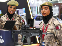 Two women officers from the Qatar Ministry of Defence attend the 15th edition of the Milipol Qatar 2024 Exhibition and Conference in Doha, Q...