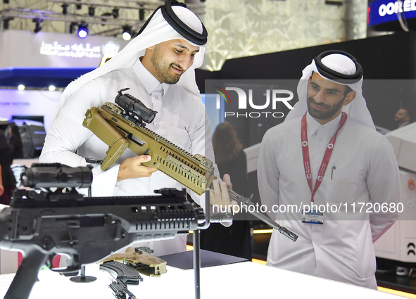 A Qatari visitor looks at the automatic gun during the 15th edition of the Milipol Qatar 2024 Exhibition and Conference in Doha, Qatar, on O...