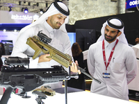 A Qatari visitor looks at the automatic gun during the 15th edition of the Milipol Qatar 2024 Exhibition and Conference in Doha, Qatar, on O...