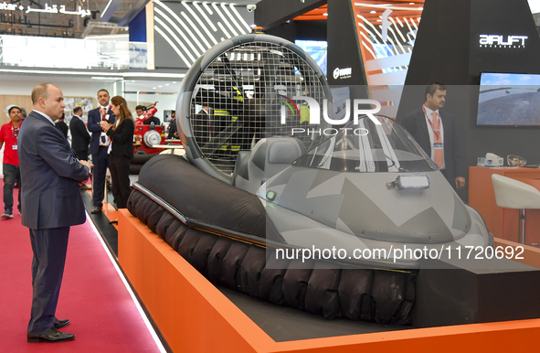 People visit an Airlift Hovercraft booth during the 15th edition of the Milipol Qatar 2024 Exhibition and Conference in Doha, Qatar, on Octo...