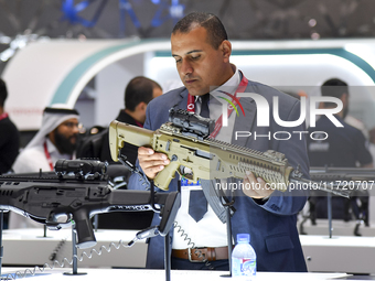 A visitor looks at the automatic gun during the 15th edition of the Milipol Qatar 2024 Exhibition and Conference in Doha, Qatar, on October...