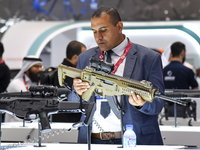 A visitor looks at the automatic gun during the 15th edition of the Milipol Qatar 2024 Exhibition and Conference in Doha, Qatar, on October...