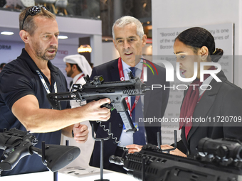 A visitor inspects an assault rifle on display at the 15th edition of the Milipol Qatar 2024 Exhibition and Conference in Doha, Qatar, on Oc...