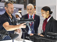 A visitor inspects an assault rifle on display at the 15th edition of the Milipol Qatar 2024 Exhibition and Conference in Doha, Qatar, on Oc...