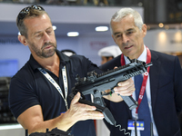 A visitor inspects an assault rifle on display at the 15th edition of the Milipol Qatar 2024 Exhibition and Conference in Doha, Qatar, on Oc...