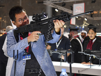 A visitor inspects an assault rifle on display at the 15th edition of the Milipol Qatar 2024 Exhibition and Conference in Doha, Qatar, on Oc...