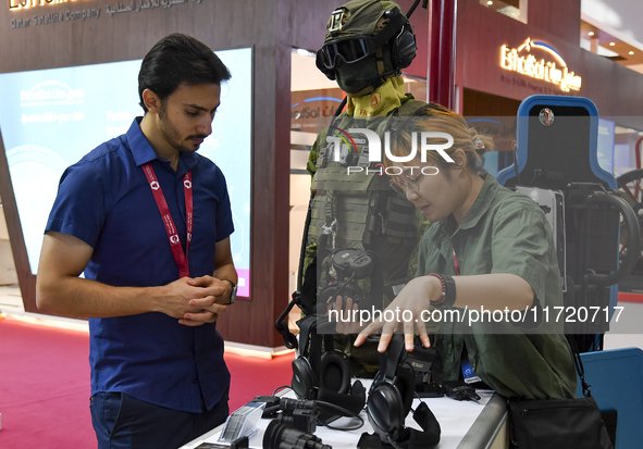 Visitors look at exhibits at the 15th edition of the Milipol Qatar 2024 Exhibition and Conference in Doha, Qatar, on October 29, 2024. The M...