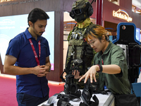 Visitors look at exhibits at the 15th edition of the Milipol Qatar 2024 Exhibition and Conference in Doha, Qatar, on October 29, 2024. The M...