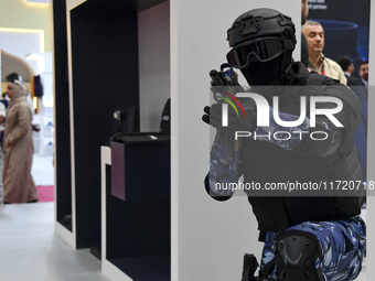 A mannequin holds an assault rifle and displays an urban combat uniform during the 15th edition of the Milipol Qatar 2024 Exhibition and Con...