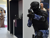 A mannequin holds an assault rifle and displays an urban combat uniform during the 15th edition of the Milipol Qatar 2024 Exhibition and Con...