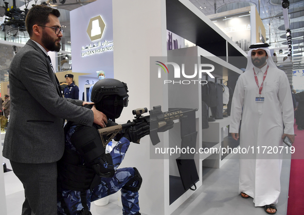 Visitors look at exhibits at the 15th edition of the Milipol Qatar 2024 Exhibition and Conference in Doha, Qatar, on October 29, 2024. The M...