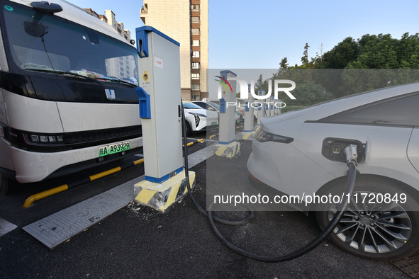 Electric vehicles are charged at a street charging station in Fuyang, China, on October 30, 2024. 