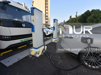 Electric vehicles are charged at a street charging station in Fuyang, China, on October 30, 2024. (