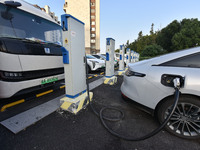 Electric vehicles are charged at a street charging station in Fuyang, China, on October 30, 2024. (