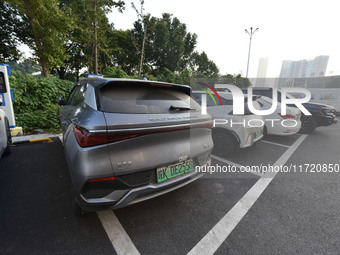 Electric vehicles are charged at a street charging station in Fuyang, China, on October 30, 2024. (