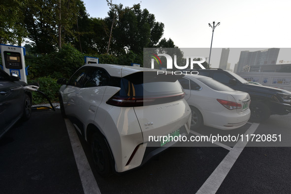 Electric vehicles are charged at a street charging station in Fuyang, China, on October 30, 2024. 