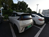 Electric vehicles are charged at a street charging station in Fuyang, China, on October 30, 2024. (