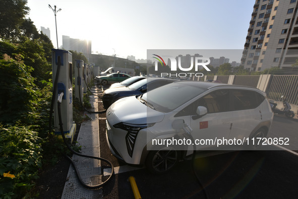 Electric vehicles are charged at a street charging station in Fuyang, China, on October 30, 2024. 