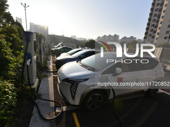 Electric vehicles are charged at a street charging station in Fuyang, China, on October 30, 2024. (