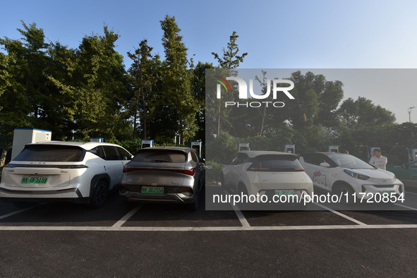 Electric vehicles are charged at a street charging station in Fuyang, China, on October 30, 2024. 