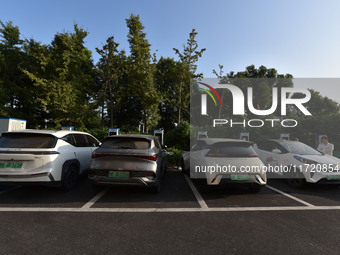 Electric vehicles are charged at a street charging station in Fuyang, China, on October 30, 2024. (