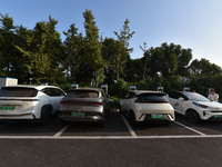 Electric vehicles are charged at a street charging station in Fuyang, China, on October 30, 2024. (