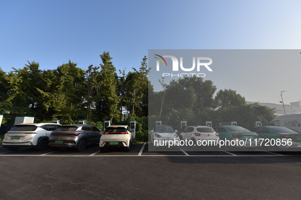 Electric vehicles are charged at a street charging station in Fuyang, China, on October 30, 2024. 