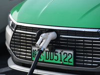 Electric vehicles are charged at a street charging station in Fuyang, China, on October 30, 2024. (