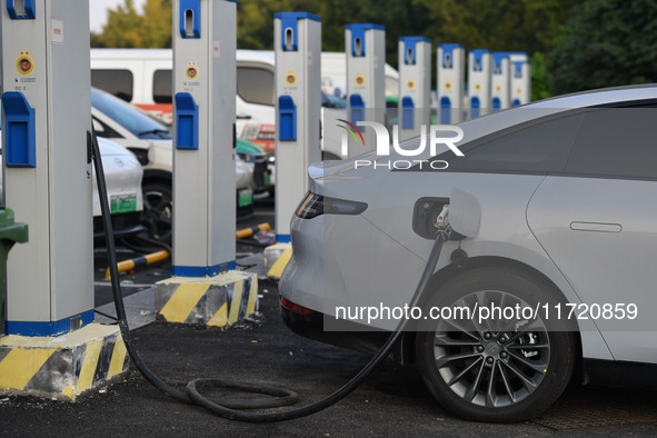 Electric vehicles are charged at a street charging station in Fuyang, China, on October 30, 2024. 