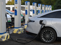 Electric vehicles are charged at a street charging station in Fuyang, China, on October 30, 2024. (