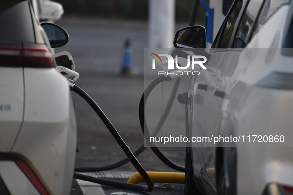 Electric vehicles are charged at a street charging station in Fuyang, China, on October 30, 2024. 