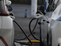 Electric vehicles are charged at a street charging station in Fuyang, China, on October 30, 2024. (