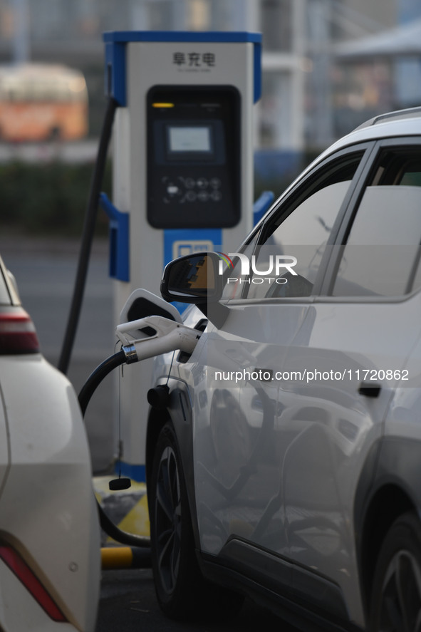 Electric vehicles are charged at a street charging station in Fuyang, China, on October 30, 2024. 