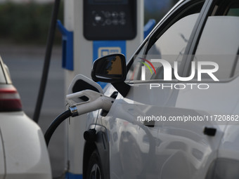 Electric vehicles are charged at a street charging station in Fuyang, China, on October 30, 2024. (