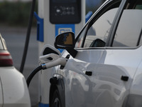 Electric vehicles are charged at a street charging station in Fuyang, China, on October 30, 2024. (