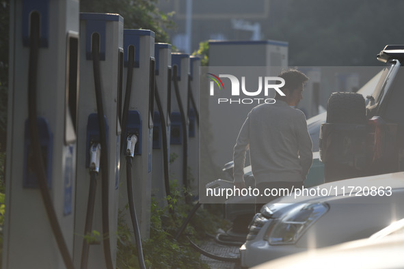 Electric vehicles are charged at a street charging station in Fuyang, China, on October 30, 2024. 