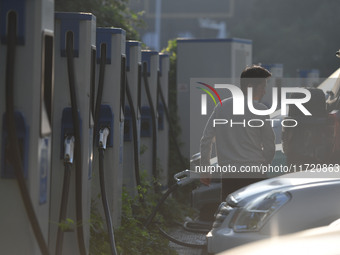 Electric vehicles are charged at a street charging station in Fuyang, China, on October 30, 2024. (