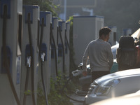 Electric vehicles are charged at a street charging station in Fuyang, China, on October 30, 2024. (