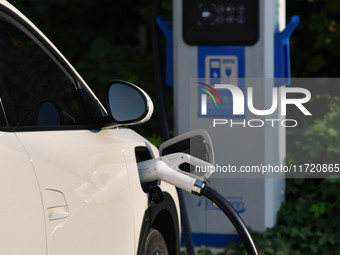 Electric vehicles are charged at a street charging station in Fuyang, China, on October 30, 2024. (