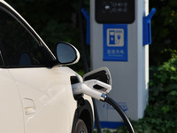 Electric vehicles are charged at a street charging station in Fuyang, China, on October 30, 2024. (