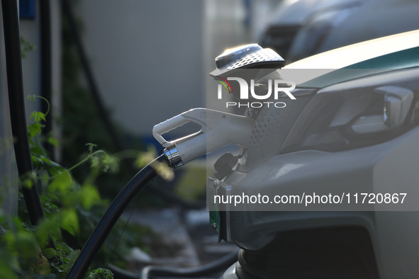 Electric vehicles are charged at a street charging station in Fuyang, China, on October 30, 2024. 