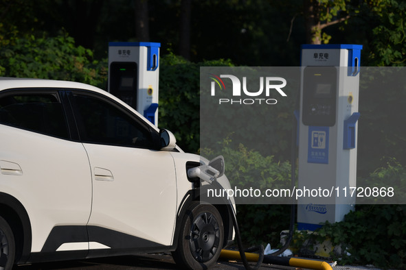 Electric vehicles are charged at a street charging station in Fuyang, China, on October 30, 2024. 