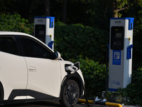 Electric vehicles are charged at a street charging station in Fuyang, China, on October 30, 2024. (