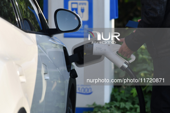 Electric vehicles are charged at a street charging station in Fuyang, China, on October 30, 2024. 