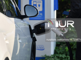 Electric vehicles are charged at a street charging station in Fuyang, China, on October 30, 2024. (