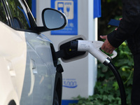 Electric vehicles are charged at a street charging station in Fuyang, China, on October 30, 2024. (