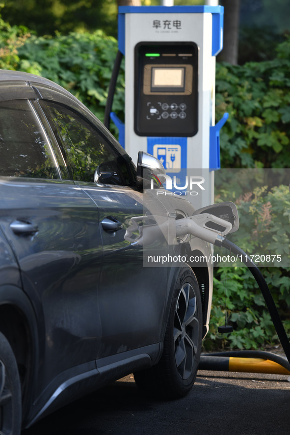 Electric vehicles are charged at a street charging station in Fuyang, China, on October 30, 2024. 