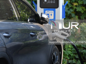 Electric vehicles are charged at a street charging station in Fuyang, China, on October 30, 2024. (