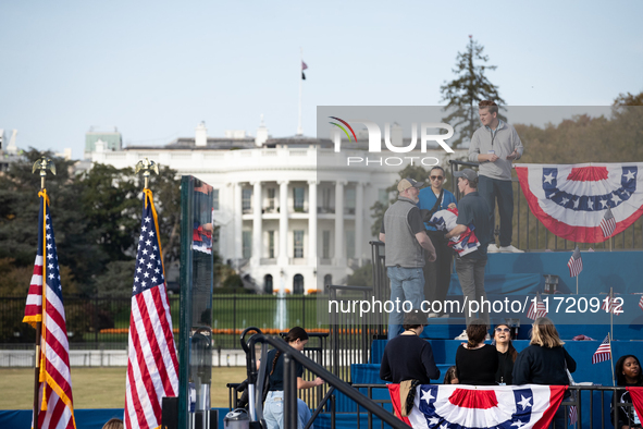 Volunteers put the final touch on stage decorations for a rally in which Vice President Kamala Harris delivers what her campaign has billed...