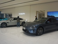 Customers buy a Xiaomi SU7 new energy vehicle at a Xiaomi Auto store in Hangzhou, China, on October 30, 2024. (